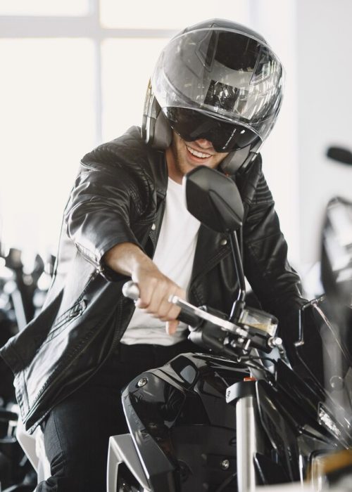 man-choosed-motorcycles-moto-shop-guy-black-jacket-man-helmet_1157-44648