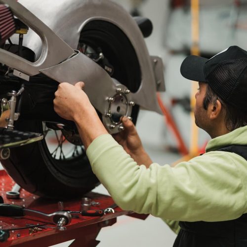 man-fixing-motorcycle-modern-workshop_158595-8087